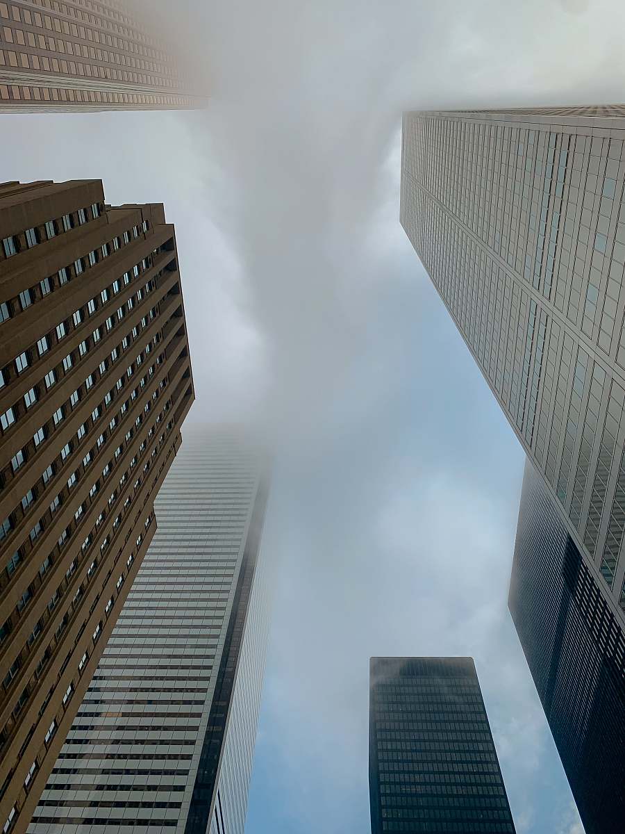 office building low-angle photography of high rise buildings under a cloudy sky town